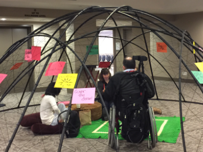Visitors seated inside the dome in conversation