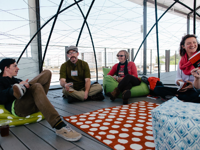 Visitors seated on cushions inside the dome at TEDxMtHood, Revolution Hall, in conversation