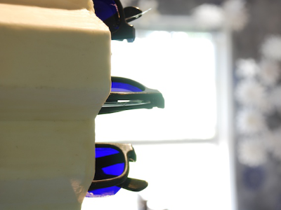 Detail of 3D glasses modified with UV-simulating film lenses, resting on a honeycomb display stand
